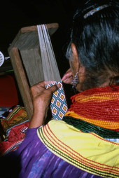Lottie Shore weaving beads to use on Seminole sash - White Springs, Florida.