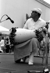Bata drummer performing Santeria music with Ernesto Pichardo at Historical Museum of Southern Florida during Traditions Festival - Miami, Florida.