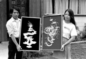 Tuan and his wife Da Nguyen displaying his Vietnamese woodwork art - Tampa, Florida.
