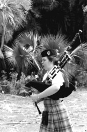 Scottish American girl playing the bagpipe at a Scottish Games event