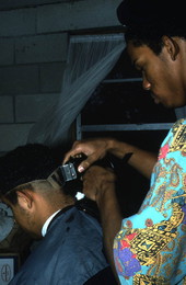 Isaac Moore getting his hair cut and styled by Teddrick Moore- White Springs, Florida
