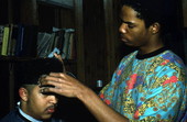 Isaac Moore getting his hair cut and styled by Teddrick Moore- White Springs, Florida