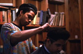 Isaac Moore getting his hair cut and styled by Teddrick Moore- White Springs, Florida