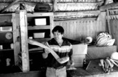Bobby Henry showing an oversized "sofkee" spoon, used to serve a Seminole corn meal drink, in his shop- Tampa, Florida