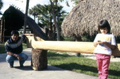 Bobby Henry (L) and Jeanette Cypress' daughter standing with a dugout canoe- Tampa, Florida
