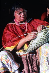 Seminole woman weaving a palmetto basket