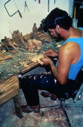 Jose Orta carving wood santos figurines- Miami, Florida