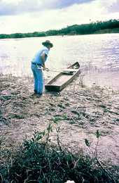 Glen Simmons pushing his glades skiff boat into the water.