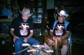 Apprentice (L) Randy Stewart looking over a knife used to strip the bark off a white oak tree as the teacher Bobby Johns looks on