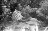 Drumming mentor Florencio Baro playing conga drums during an instruction session about the rhythms of bembe - Miami, Florida.