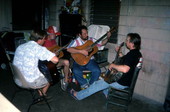Blues guitarist Tampa Blue teaching apprentices Michael Dodge, Joseph Reina, and David Kirby how to play the blues- Tampa, Florida.