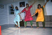 Nila Radhakrishnan (in red) teaching apprentices Prema Menon (L) and Priya Menon East Indian dance- Dade City, Florida