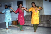Nila Radhakrishnan (in red) teaching apprentices Prema Menon (L) and Priya Menon East Indian dance- Dade City, Florida