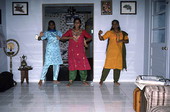 Nila Radhakrishnan (in red) teaching apprentices Prema Menon (L) and Priya Menon East Indian dance- Dade City, Florida