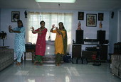 Nila Radhakrishnan (in red) teaching apprentices Prema Menon (L) and Priya Menon East Indian dance- Dade City, Florida