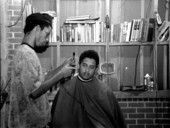 Isaac Moore getting his hair cut and styled by Teddrick Moore- White Springs, Florida