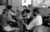 Blues guitarist Tampa Blue (center) teaching apprentices Michael Dodge, Joseph Reina, and David Kirby how to play the blues- Tampa, Florida.