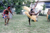 Nigerian acrobatic dancer Felix Omeben performs as Augustine Omeben (l) looks on - North Miami, Florida