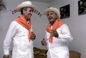 Cuban guajiro apprentice, Mario Brito, left, smiles as Meliton Perdomo sings a decima - Medley, Florida