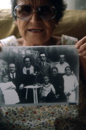 Erna (Baumann) Parpard holding up a photograph of her family - Boynton Beach, Florida.