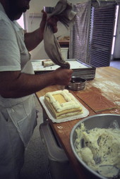 Baker Mike Caforio filling sponge cake with cheese - Lake Worth, Florida.