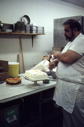 Baker Mike Caforio frosting cake with whipped cream - Lake Worth, Florida.
