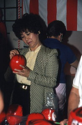 Woman painting daruma doll at Japanese New Years celebration - Delray Beach, Florida.