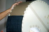 Black crepe paper being glued on Mickey Mouse head pinata by maker Sylvia Garcia - West Palm Beach, Florida.
