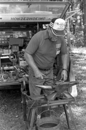 Farrier John Flaherty working on a horseshoe at the 1988 Florida Folk Festival - White Springs, Florida