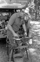 Farrier John Flaherty working on a horseshoe at the 1988 Florida Folk Festival - White Springs, Florida