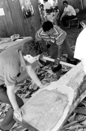 Bobby Henry, center, starting to work on a dugout canoe at the 1988 Florida Folk Festival - White Springs, Florida