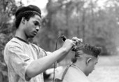 Isaac Moore getting his hair cut and styled by Teddrick Moore- White Springs, Florida.