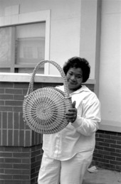 Margaret Garrison poses with one of her sweetgrass baskets