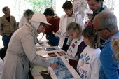 Nancy Greenberg, left, showing her hand-painted Ketubah at the Traditions Festival - Miami, Florida.