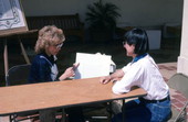 Nancy Greenberg, left, showing her hand-painted ketubah to folklorist Merri Belland at the Traditions Festival - Miami, Florida.