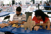 Jose Orta and unidentified artisan demonstrating wood-carving at the Traditions Festival - Miami, Florida.