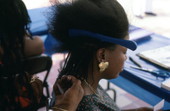 Woman having her hair braided at the Traditions Festival - Miami, Florida.