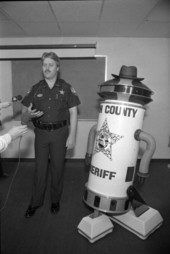 Deputy Sheriff Lowell McDonald with Leon County Sheriff robot character in Tallahassee, Florida.