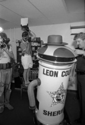 Photographers taking pictures of Leon County Sheriff's robot character in Tallahassee, Florida.