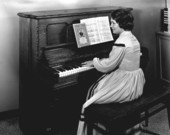 Suzette Cason playing an upright piano at the Stephen Foster Center - White Springs, Florida