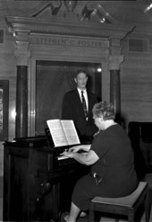 John Burton of Clewiston singing carols to piano accompaniment by Doris Strong during Christmas program at the Stephen Foster Center