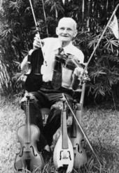 Portrait of fiddler Zeke Stephens with his fiddles in Panama City, Florida.