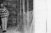Net maker standing next to a fishing net in Key West, Florida.