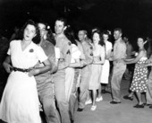 Servicemen in a conga line with women at the Gainesville Recreation Department's Service Center.