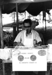 Pedro Gomez rolling cigars at a booth