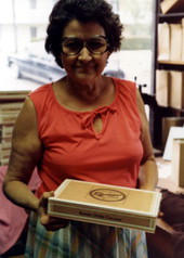 Woman holding a box of hand made cigars