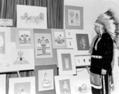 Creek Indian painter Fred Beaver looking at his artwork at the 1954 Florida Folk Festival- White Springs, Florida