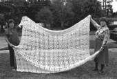 Maria Birchfield and Benia Birchfield holding up a crochet spread - Saint Augustine, Florida