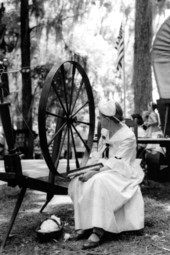 Jessie Coker sitting with her cotton spinning wheel- White Springs, Florida