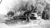 Will Newman working on a tugboat hull in the front yard - East Palatka, Florida.